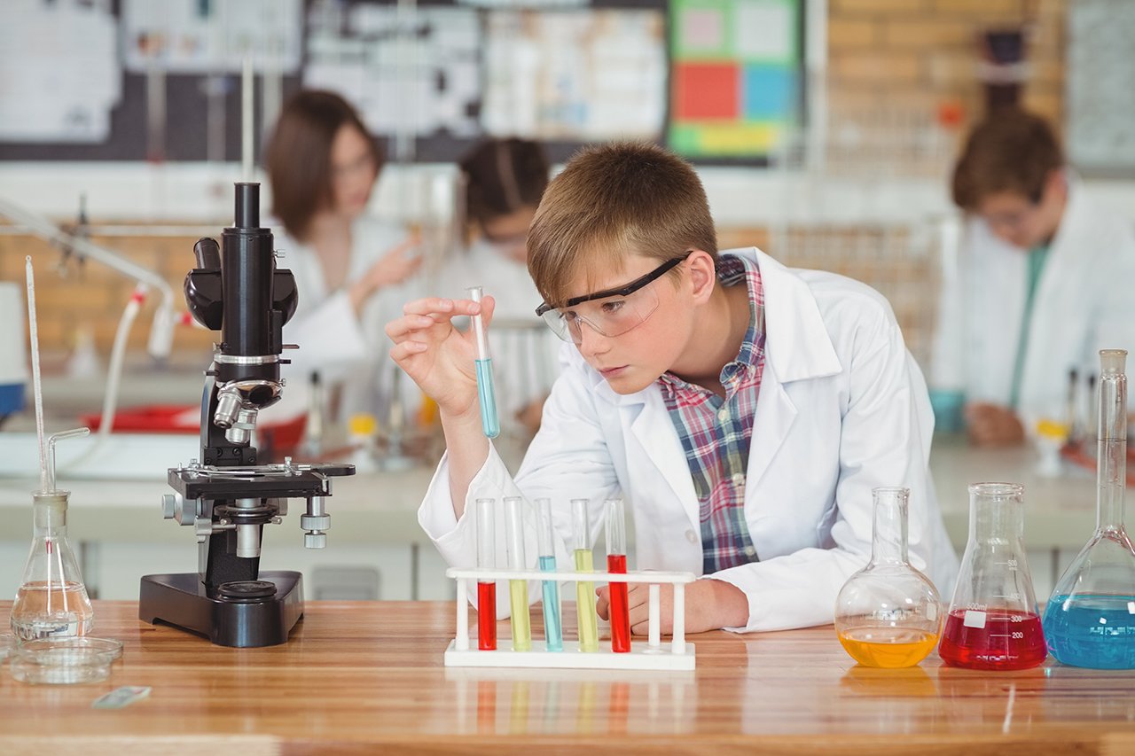 boy doing a chemical experiment in laboratory